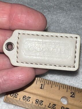 white Coach leather hang tag distinctive embossed logo purse fob